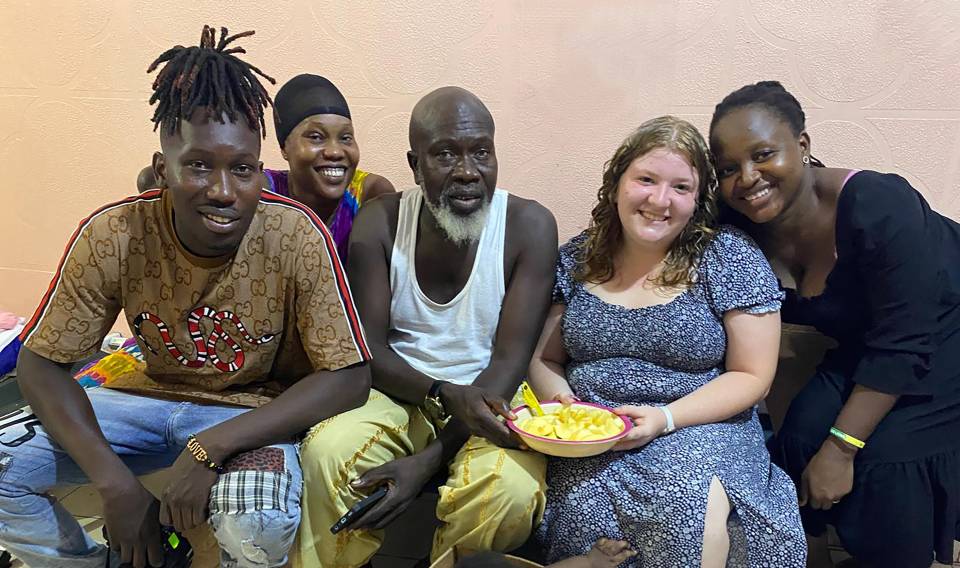 A group photo of five, taken of a Senegalese family and their bridge year student.