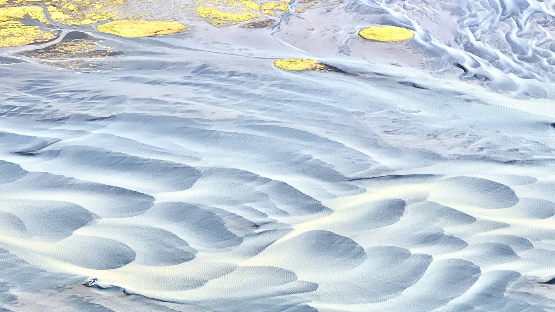 Glacial rivers creating filigree patterns across the delta