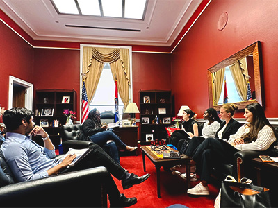 Students confer in a stately red room in DC