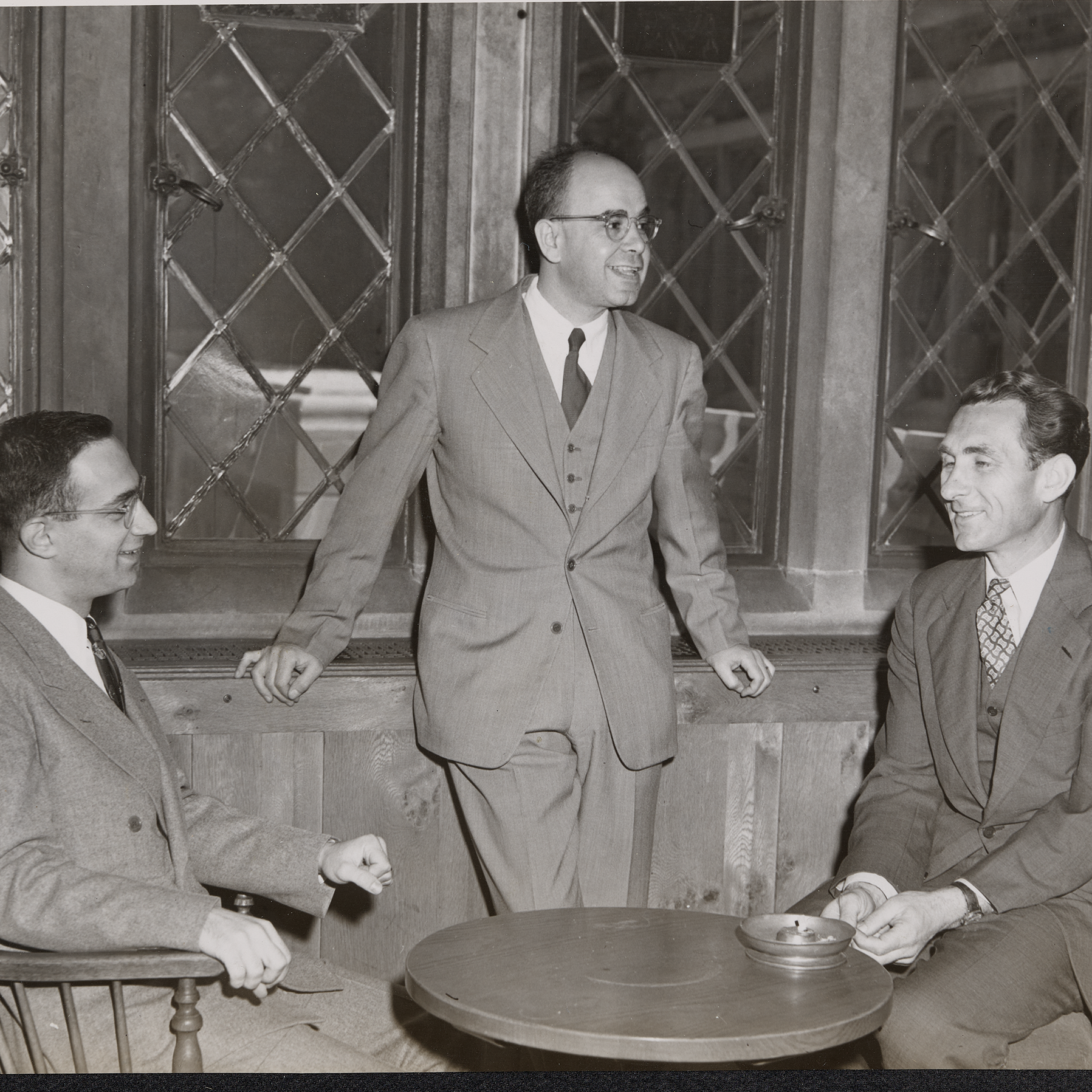 A black and white photo of three men in 1951