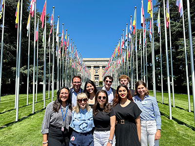 A group of SPIA students outside of the UN on a sunny day