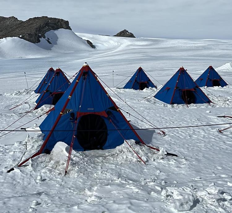 Cordsen's camp; six simple blue tents on an arctic landscape