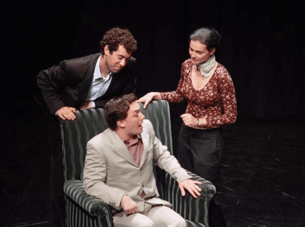 three students in a production of le Dindon