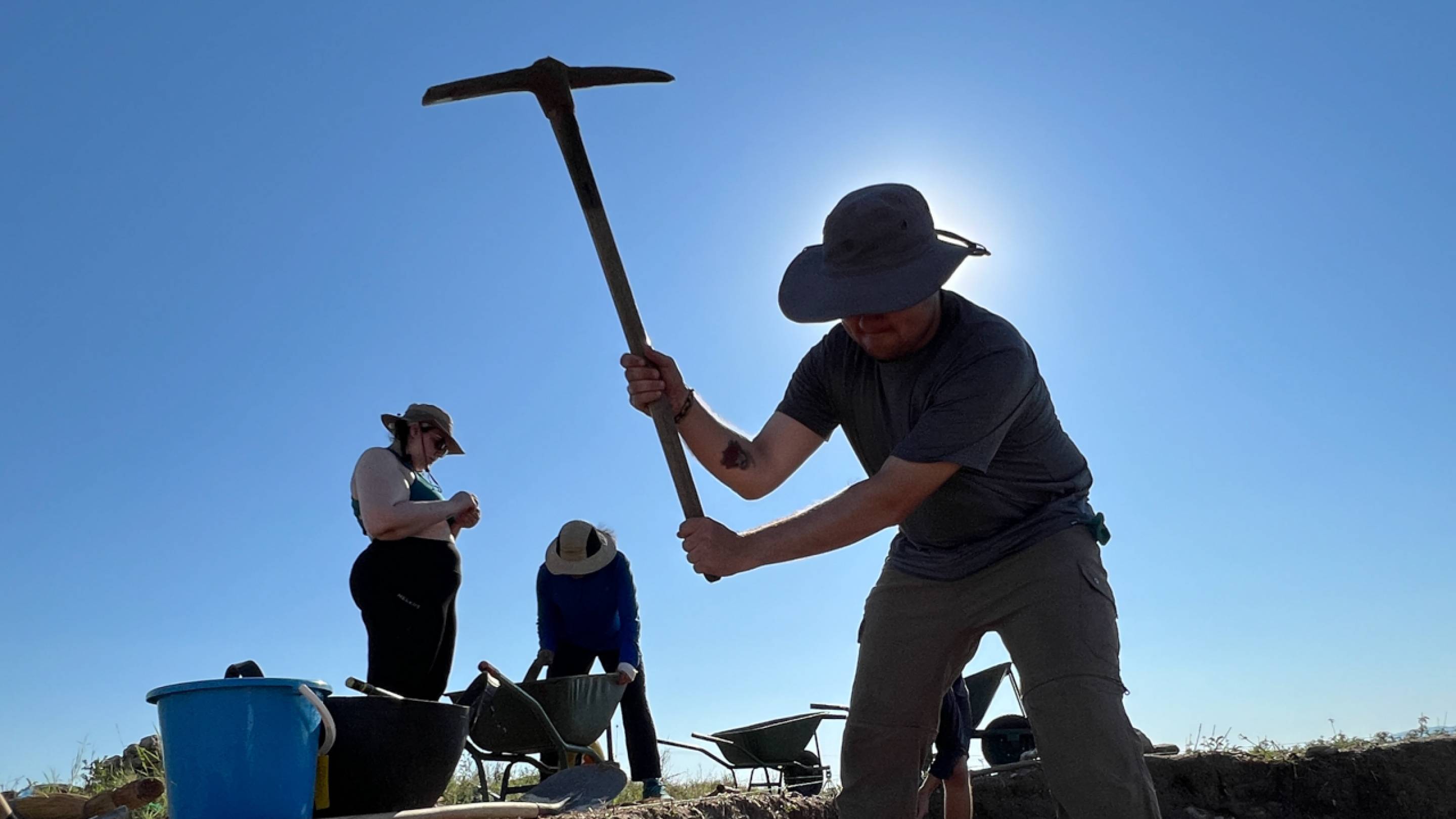 Ethan Spain ’26 uses a pickaxe to begin excavating a section of the Molyvoti, Thrace