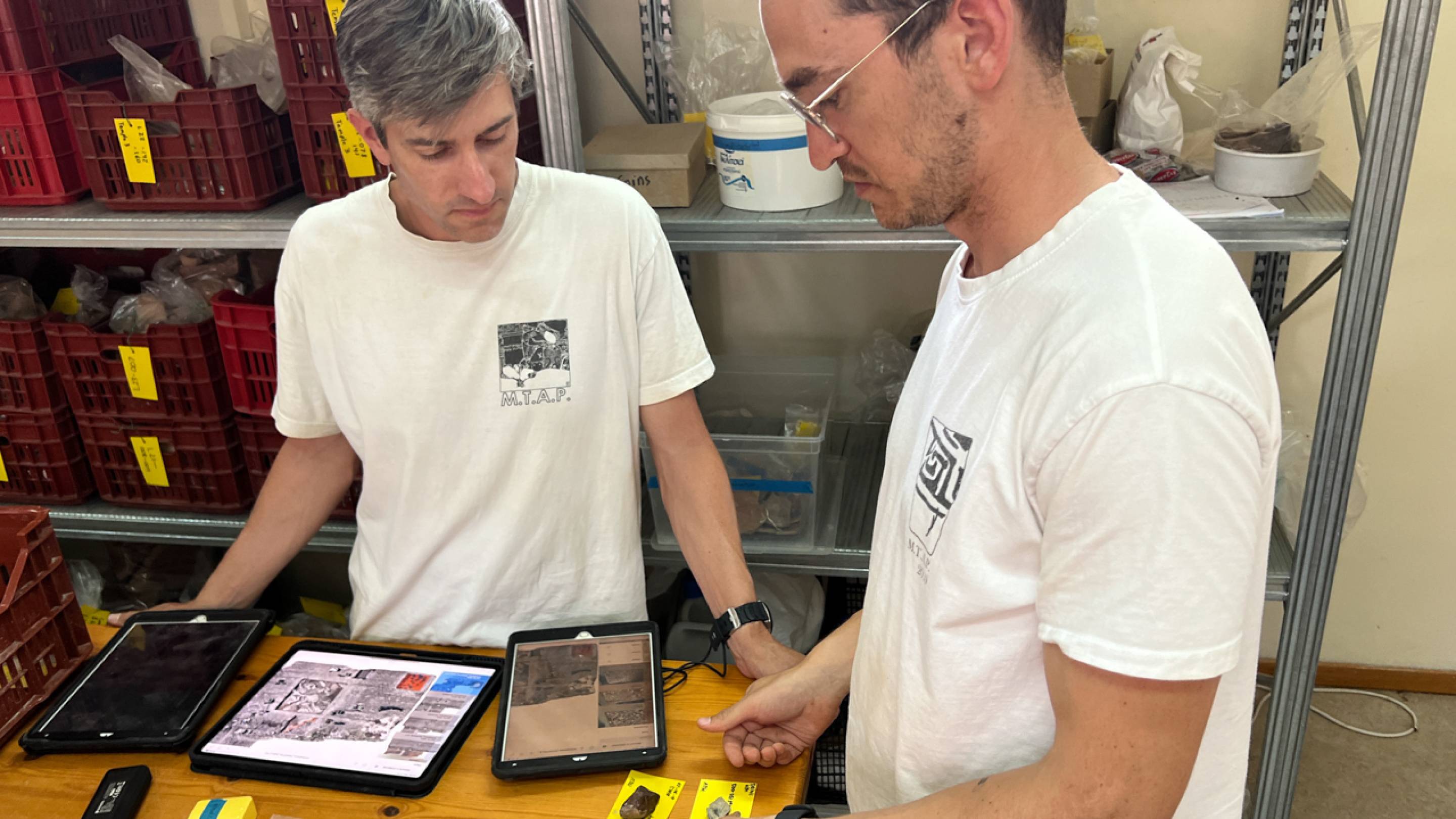 Professor Nathan Arrington (left) and graduate student Will Austin use iDig to examine and record pottery found at the Molyvoti, Thrace, Archaeological Project (MTAP) in Greece.