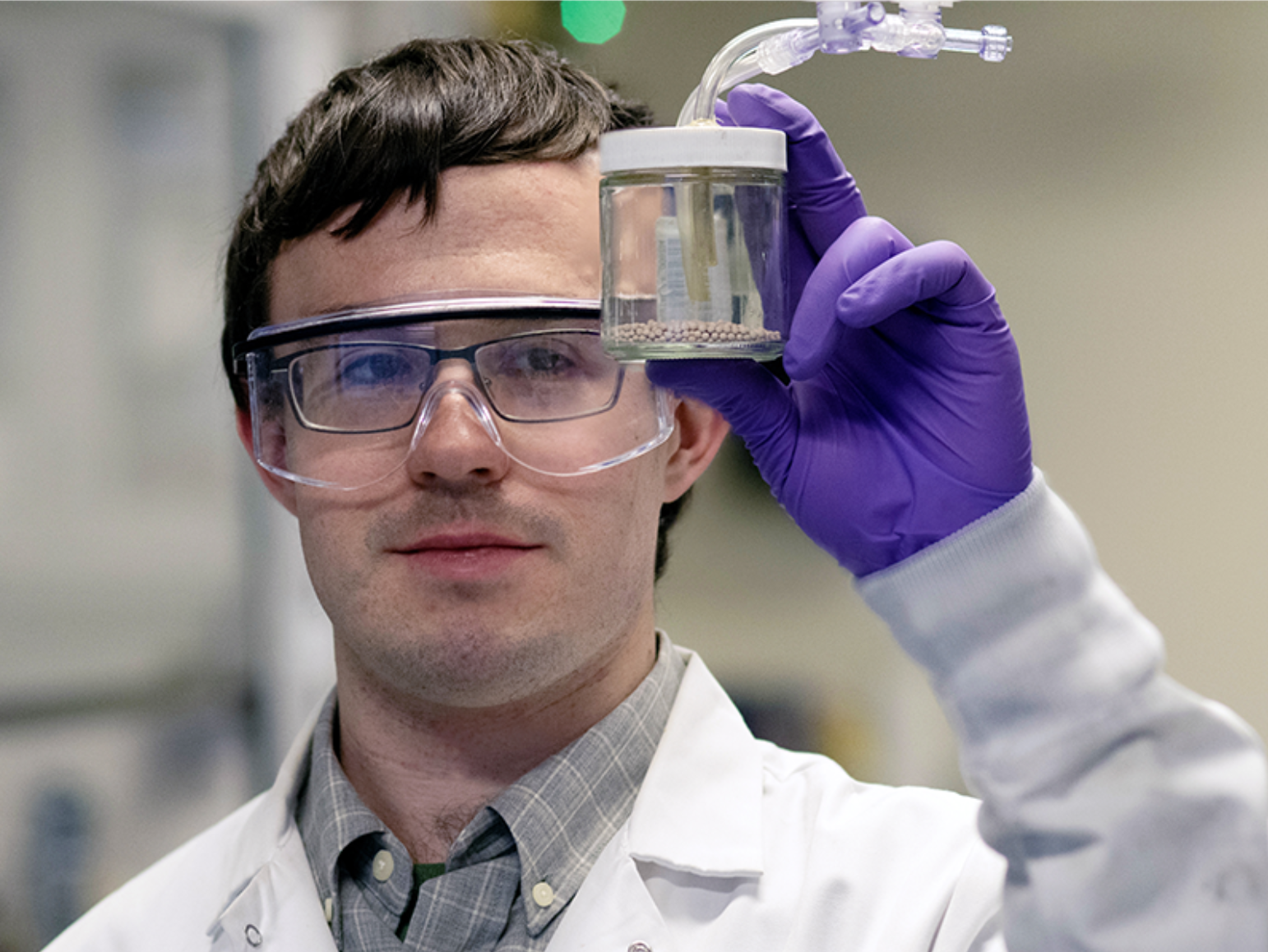 Co-author and graduate student Booth holds the carbon capture material.