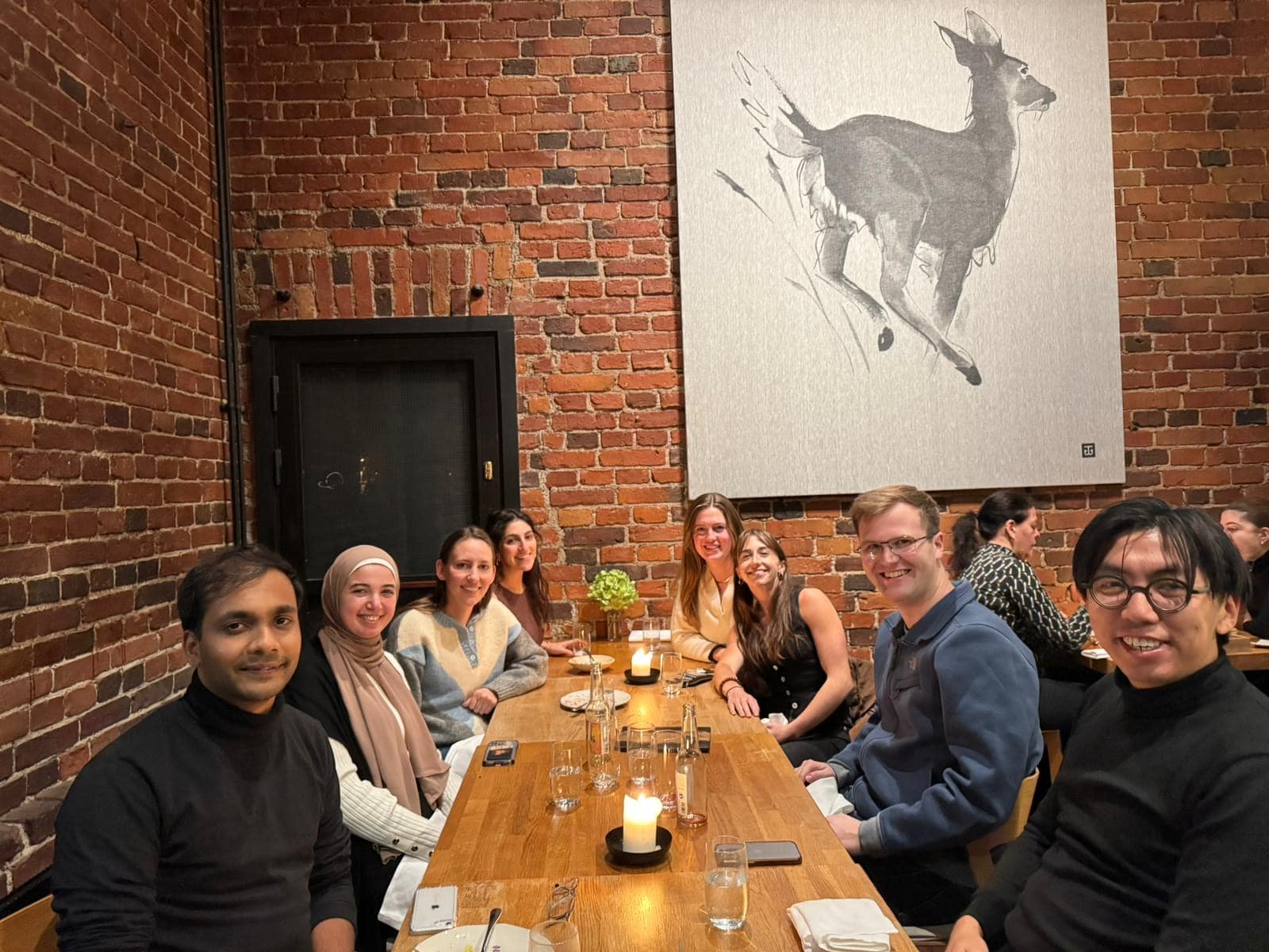 Image of students smiling in a restaurant