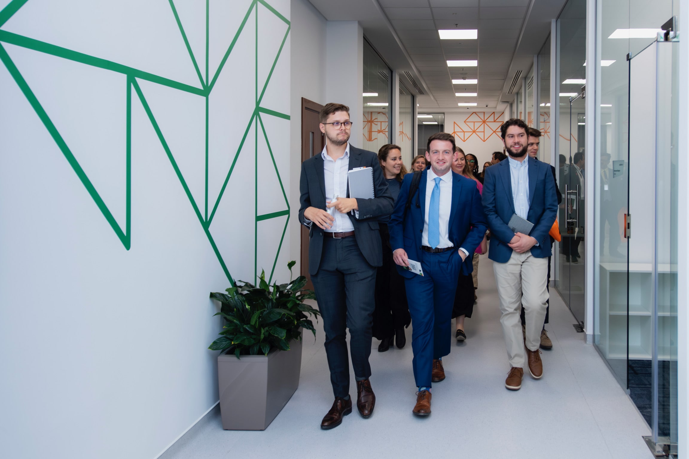 SPIA students walking in suits in a long hallway