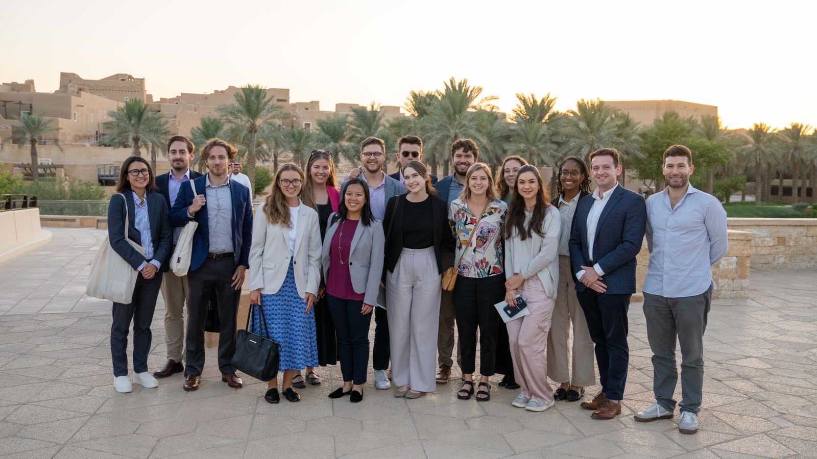 SPIA students smiling behind palm trees