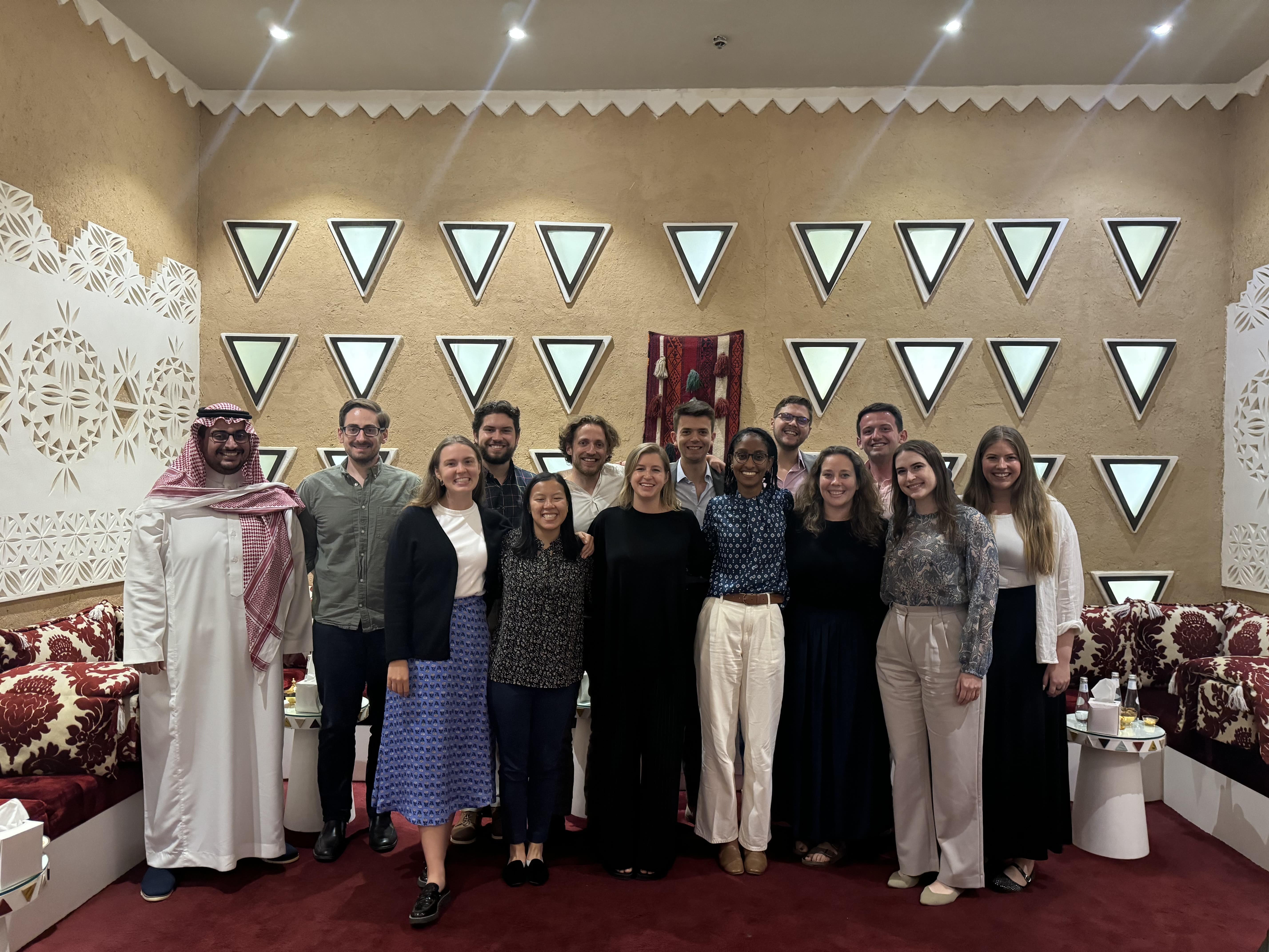 SPIA students standing in a room behind triangle decorations