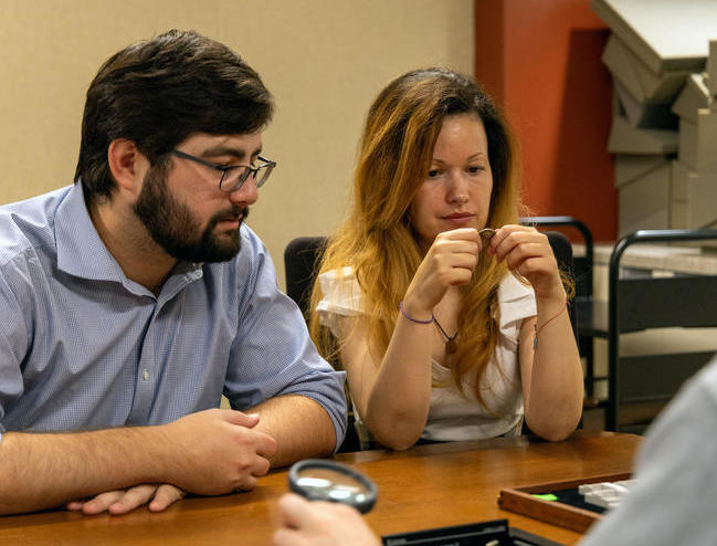 Two grad students explore numismatics