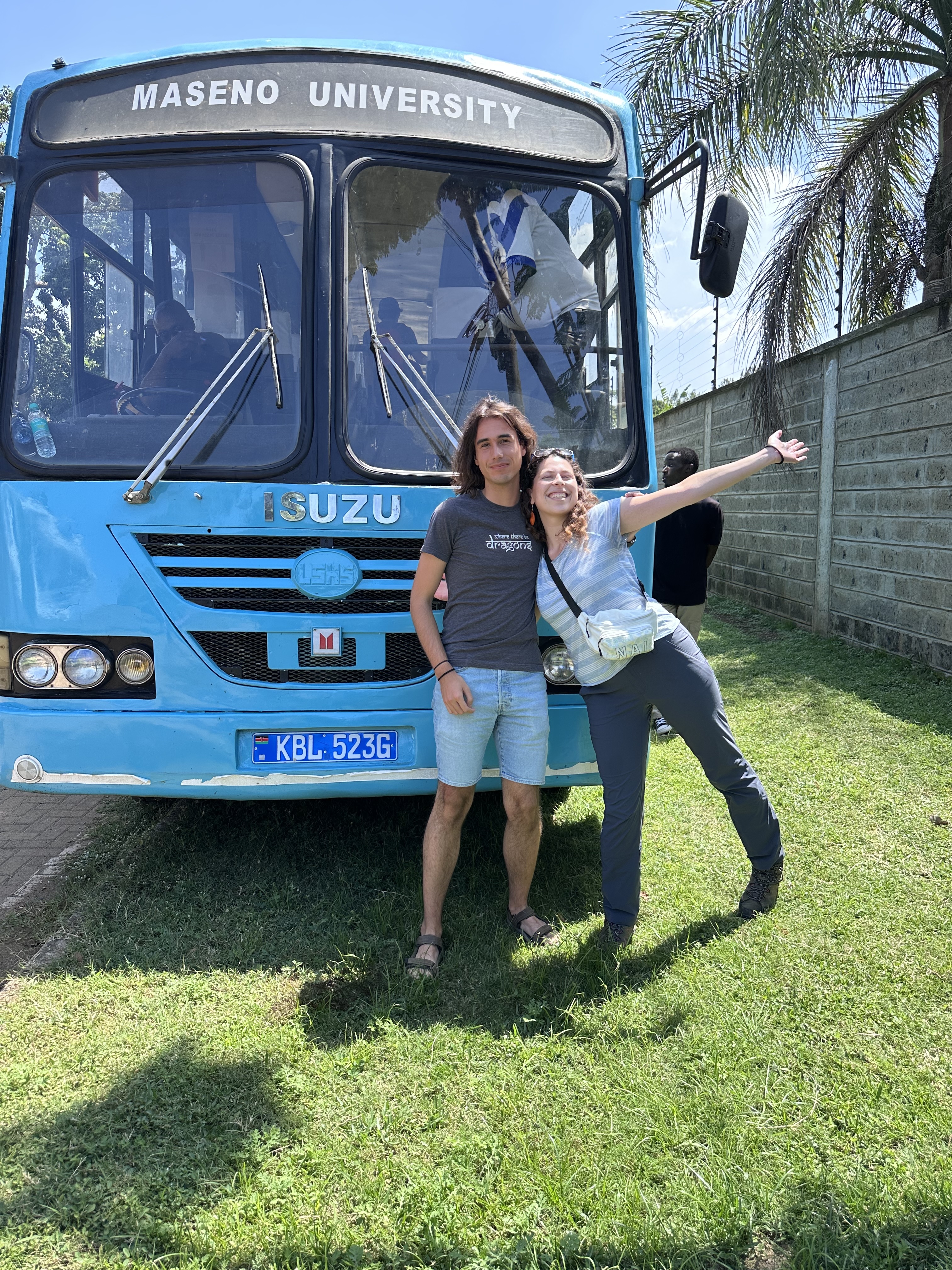 Two princeton students in front of a bus in Kenya