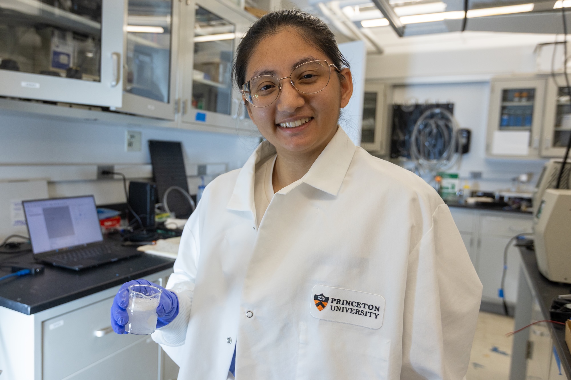 Scientist smiling in white lab Princeton coat
