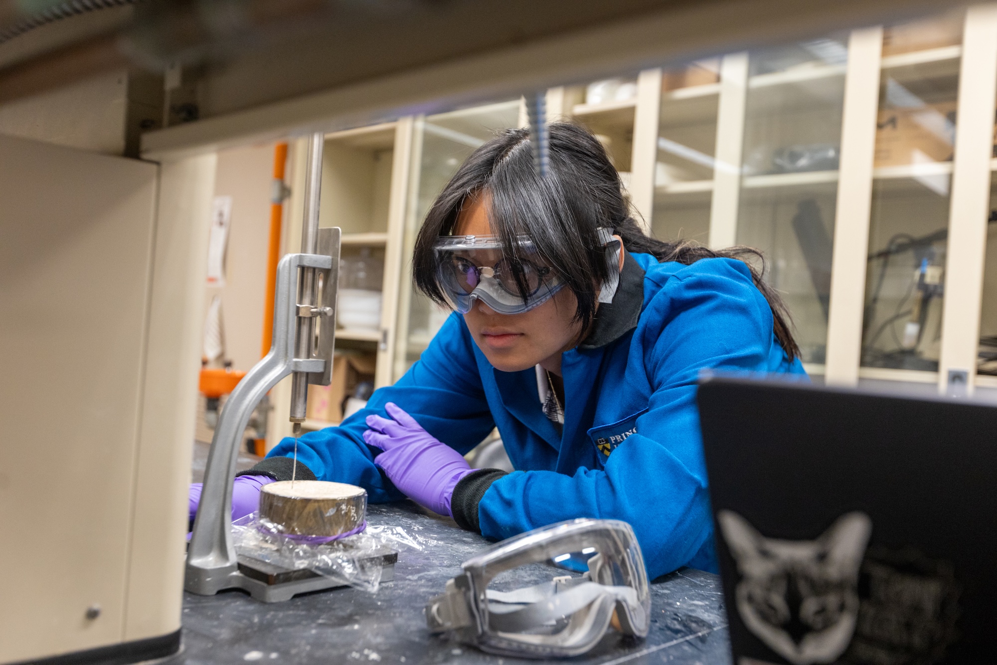 Student doing lab work with lab goggles