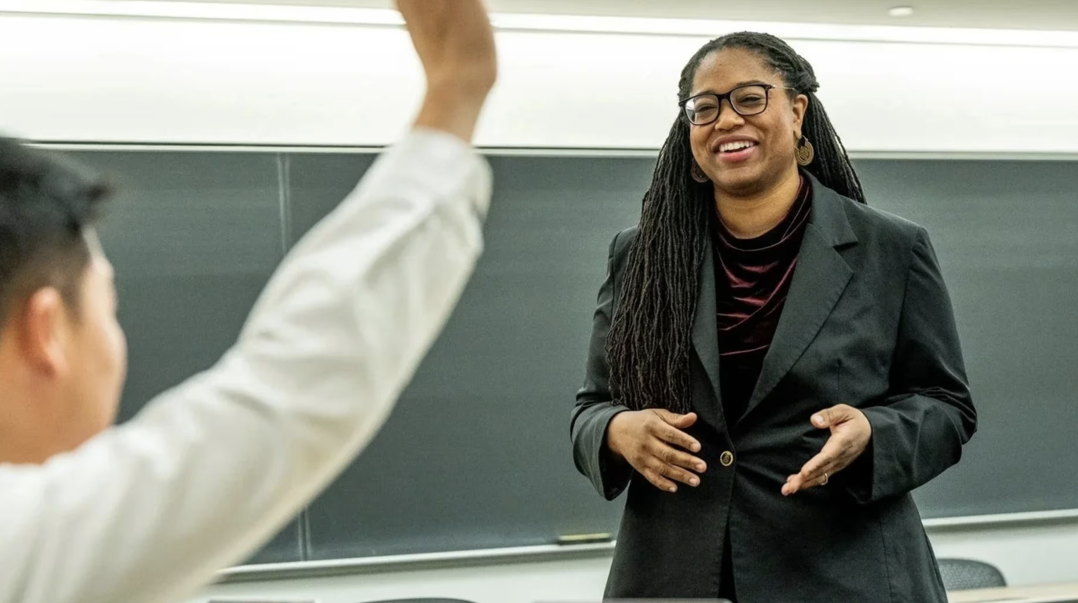 Prof GR in a class engaging with a student