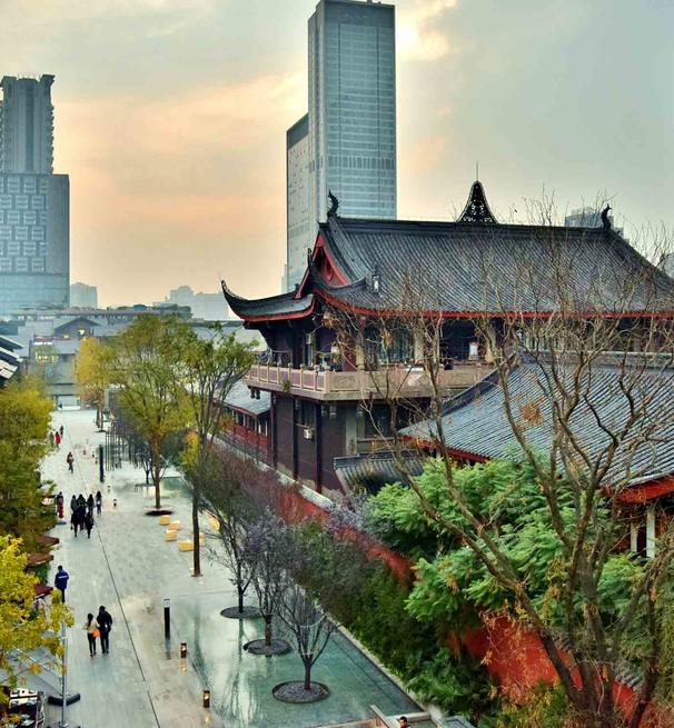 A photo showing a traditional chinese pagoda with modern skyscrapers in the distance