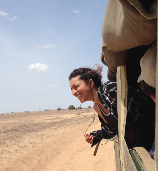 Student leans out of a safari vehicle in Kenya