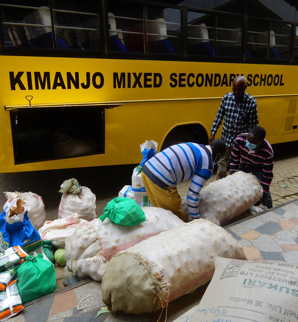 bagged foodstuffs being loaded into a school bus