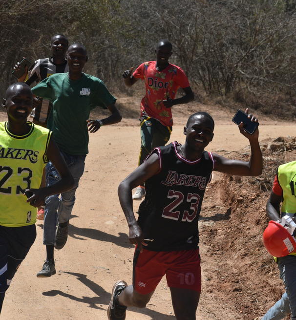 a group of Africans running in a marathon