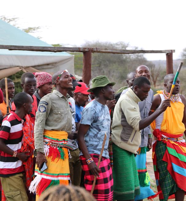 a group of students and locals dressed in Kenyan costumes