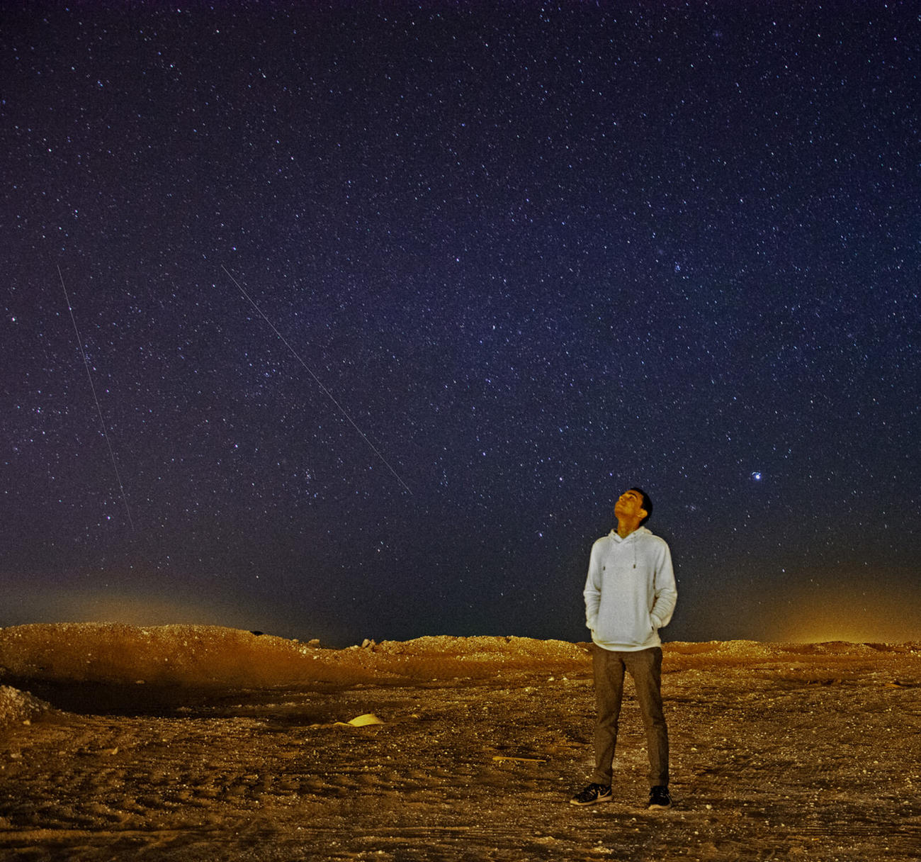 A man gazes up a star-filled sky