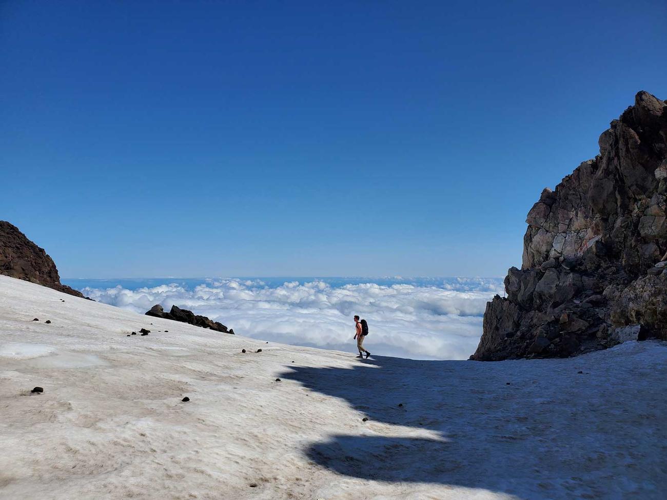 A lone figure against a snowy mountainous background