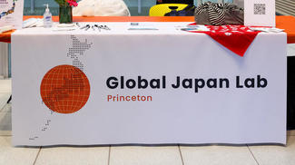 A table set up with a table cloth promoting the Global Japan Lab