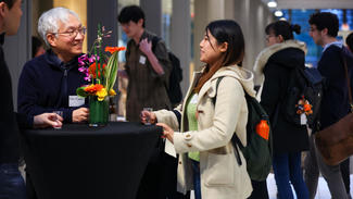 GJL affiliated faculty member Nobuhiro Kiyotaki (left), the Harold H. Helm '20 Professor of Economics and Banking speaks to Lynn Hirose, a graduate student in the Department of Atmospheric and Oceanic Sciences. 