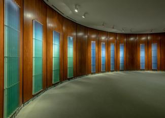 An art installation called Sea Ice Daily Drawings; several vertical canvases arrayed in a wood paneled room.