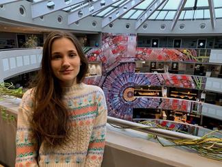 shot of female student next to giant spiral staircase