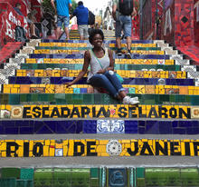A woman sits on steps in Rio De Janeiro.