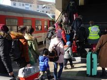 Refugees exit the train after arriving in Hannover. They then went to a reception center at a nearby exhibition hall to in-process before continuing on to their final destinations. Photo courtesy of Henry Posner III