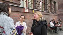 Abigail Goldberg-Zelizer interviews an art history student from Kyiv (left) who’d found work at a restaurant in Berlin, as Zara Raimbek, a film student in Berlin who speaks Ukrainian and Russian looks on.