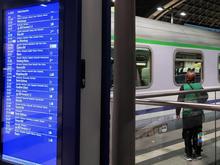 A green-vested volunteer meets a train from Warsaw to greet Ukrainian refugees.