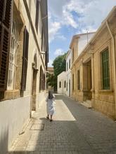A lone nun walks down an Cypriot street
