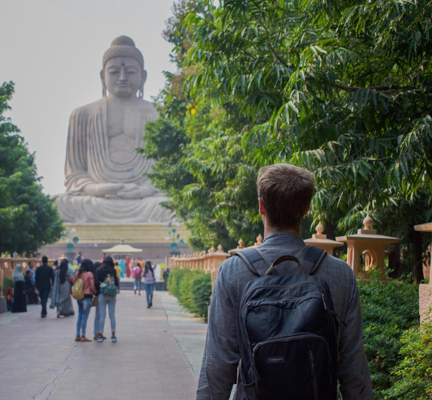 Photo of Bruce Allen and a Buddha statue