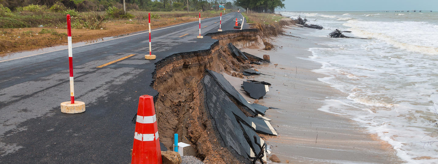 broken road along beach, eroded by storm waves