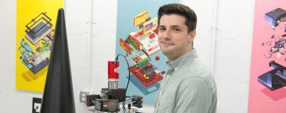 Eric Lepowsky working alongside a robot