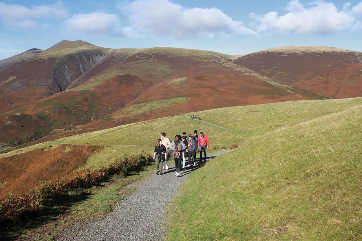 Students walking on a hilly moor. 