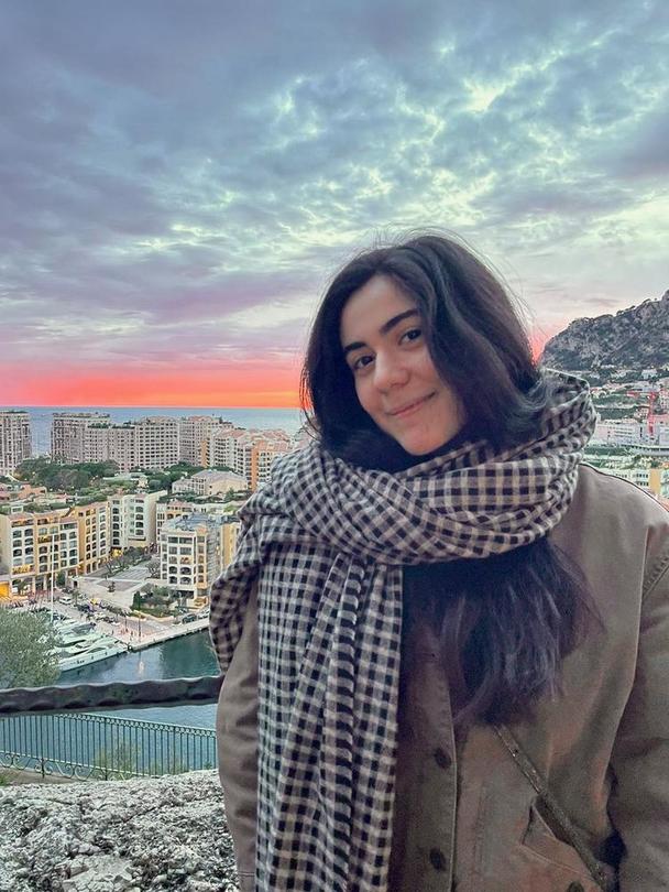 A headshot of Mikaela Avakian with a warm sunset