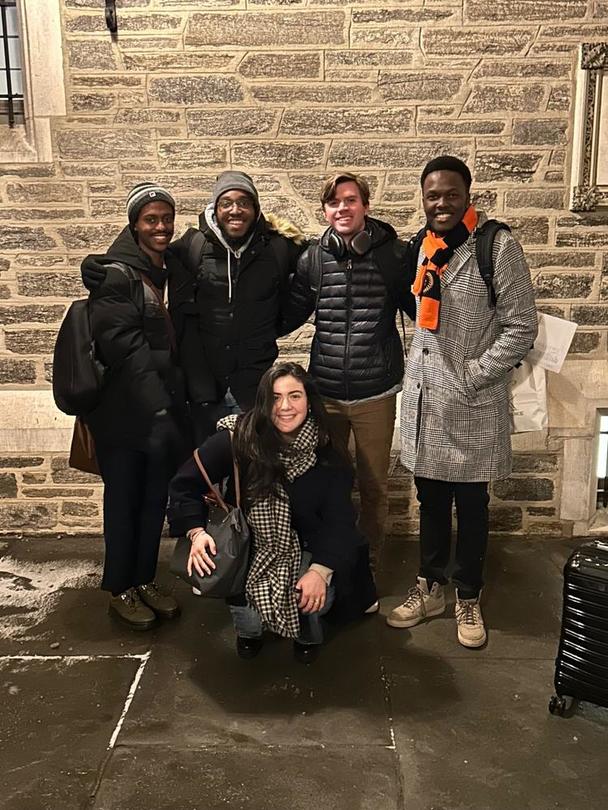 A group of five against a brick wall