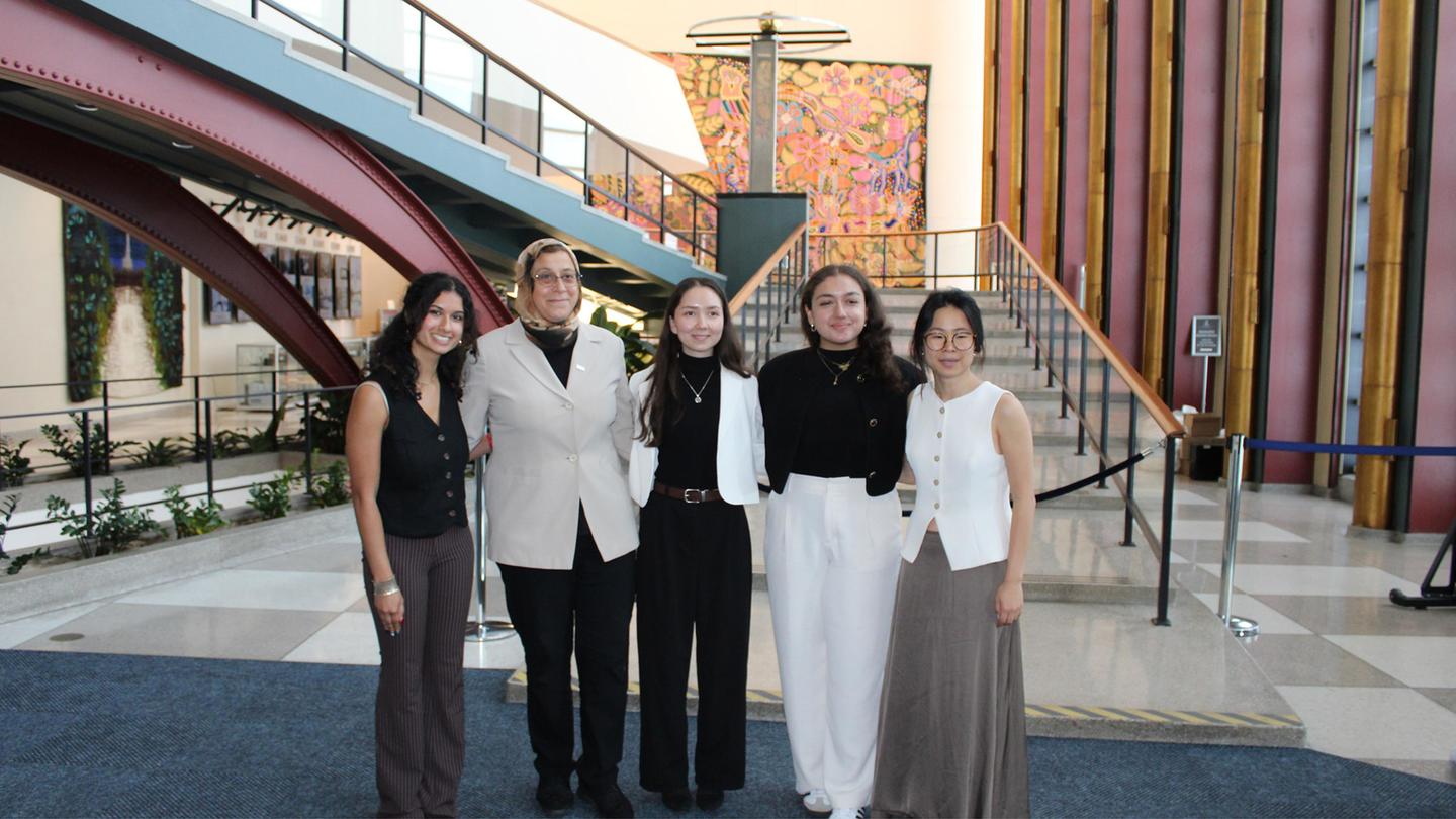 Five people posing in a picture together