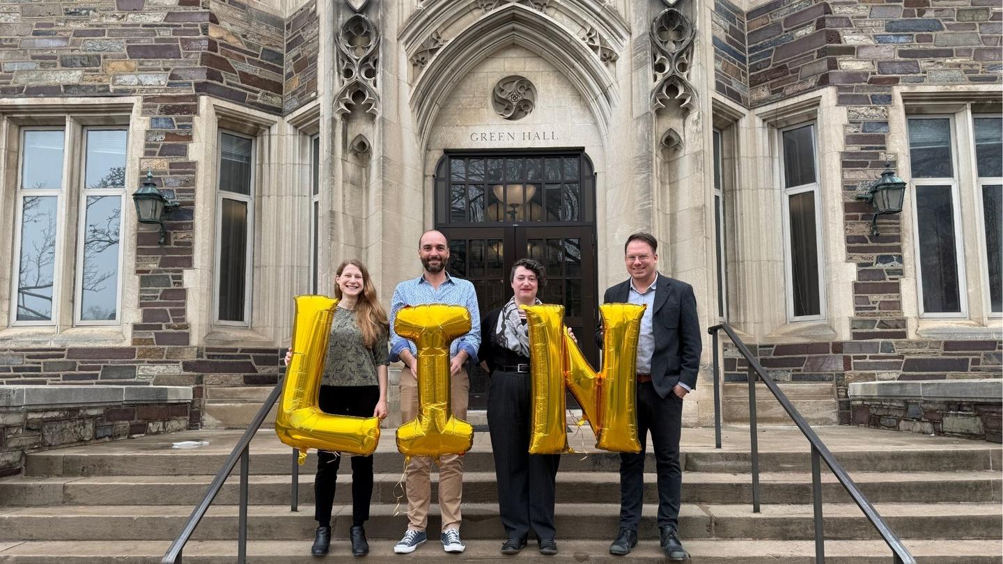 Faculty holding ballons that spell out LIN