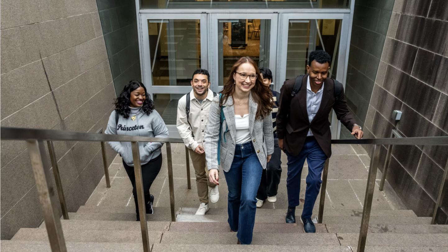 SPIA students walking up stairs and smiling