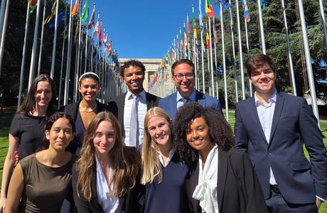 A group of 10 students and their professor in front of the UN