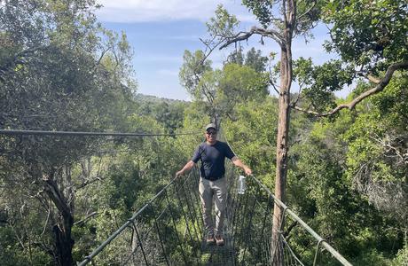 Brian Kloeppel on a forest-canopy walkway at teh Ngare Ndare Trust in Kenya. Photo by Kelsie Rouse