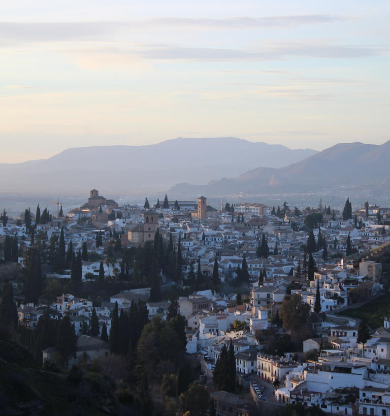 A city scape with mountains in the background