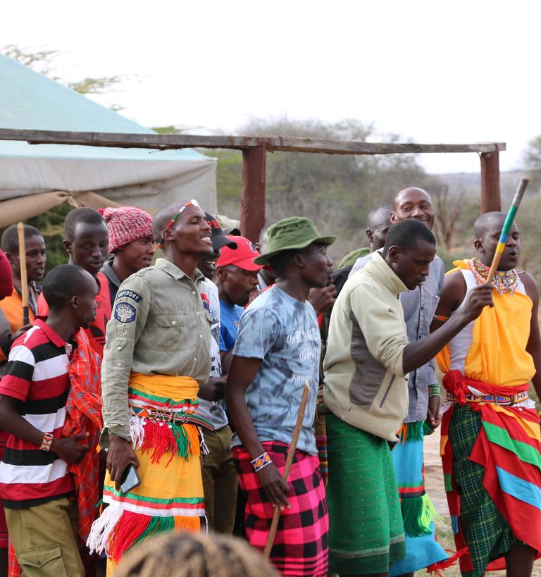 a group of students and locals dressed in Kenyan costumes